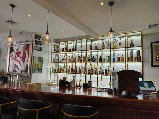 The bar counter and illuminated bottle display at Elysium.